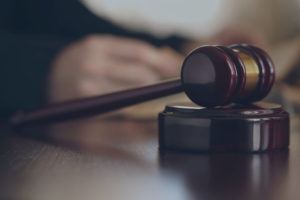 A gavel on the desk of a courtroom during a trial 